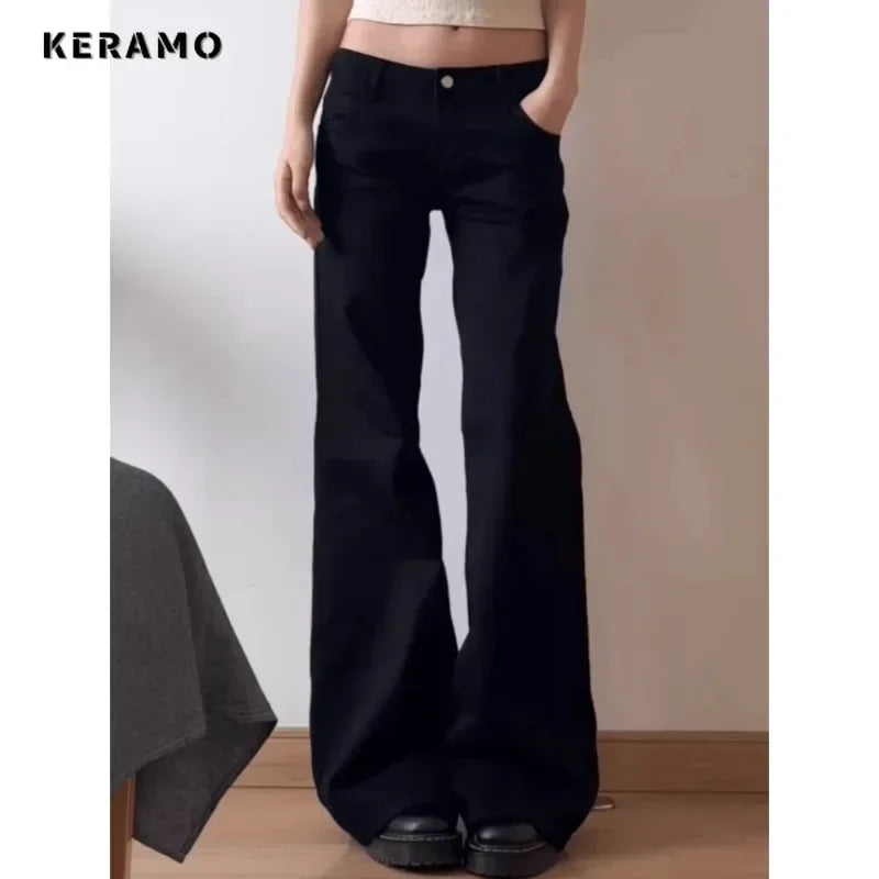 Person wearing black wide-leg pants with a plain background, featuring the brand 'Keramo'.