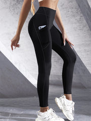 Person wearing black leggings with a pocket on a gray background
