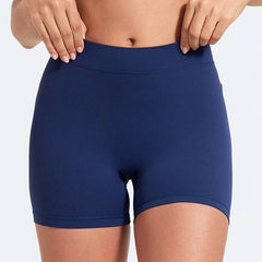 Navy blue athletic shorts worn by a person on a light gray background