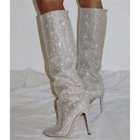 Silver glittery knee-high boots on a white background