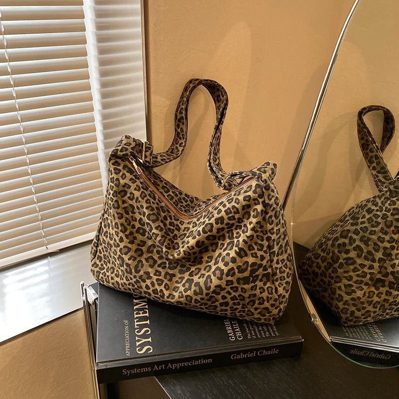 Leopard print handbag on a book with a mirror reflection