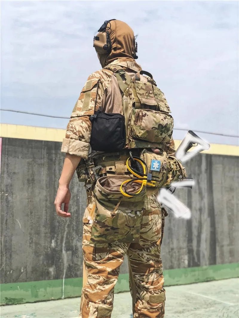 Person wearing a camouflage military-style outfit with tactical gear on a concrete surface.