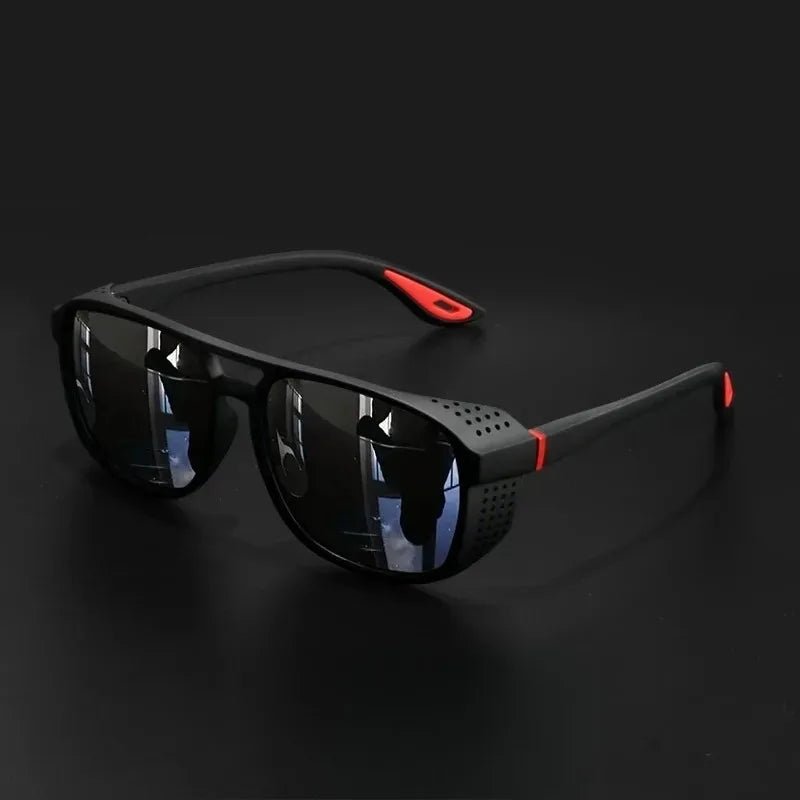 Black sunglasses with red accents on a dark background