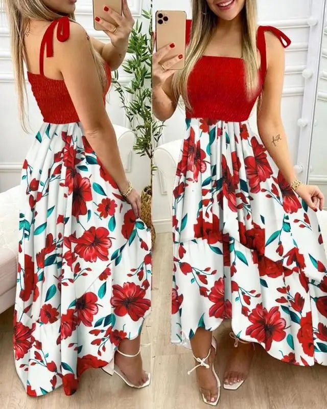 Woman wearing a red top and floral skirt, taking a mirror selfie.