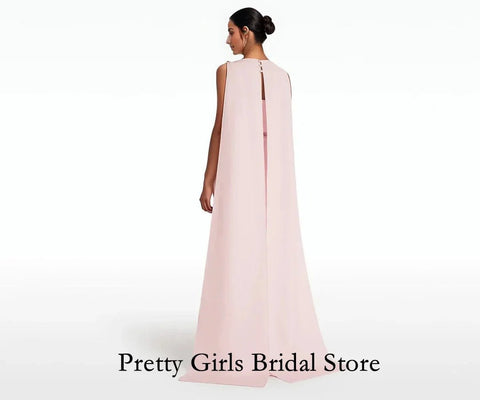 Woman wearing a light pink sleeveless gown on a white background with 'Pretty Girls Bridal Store' text.
