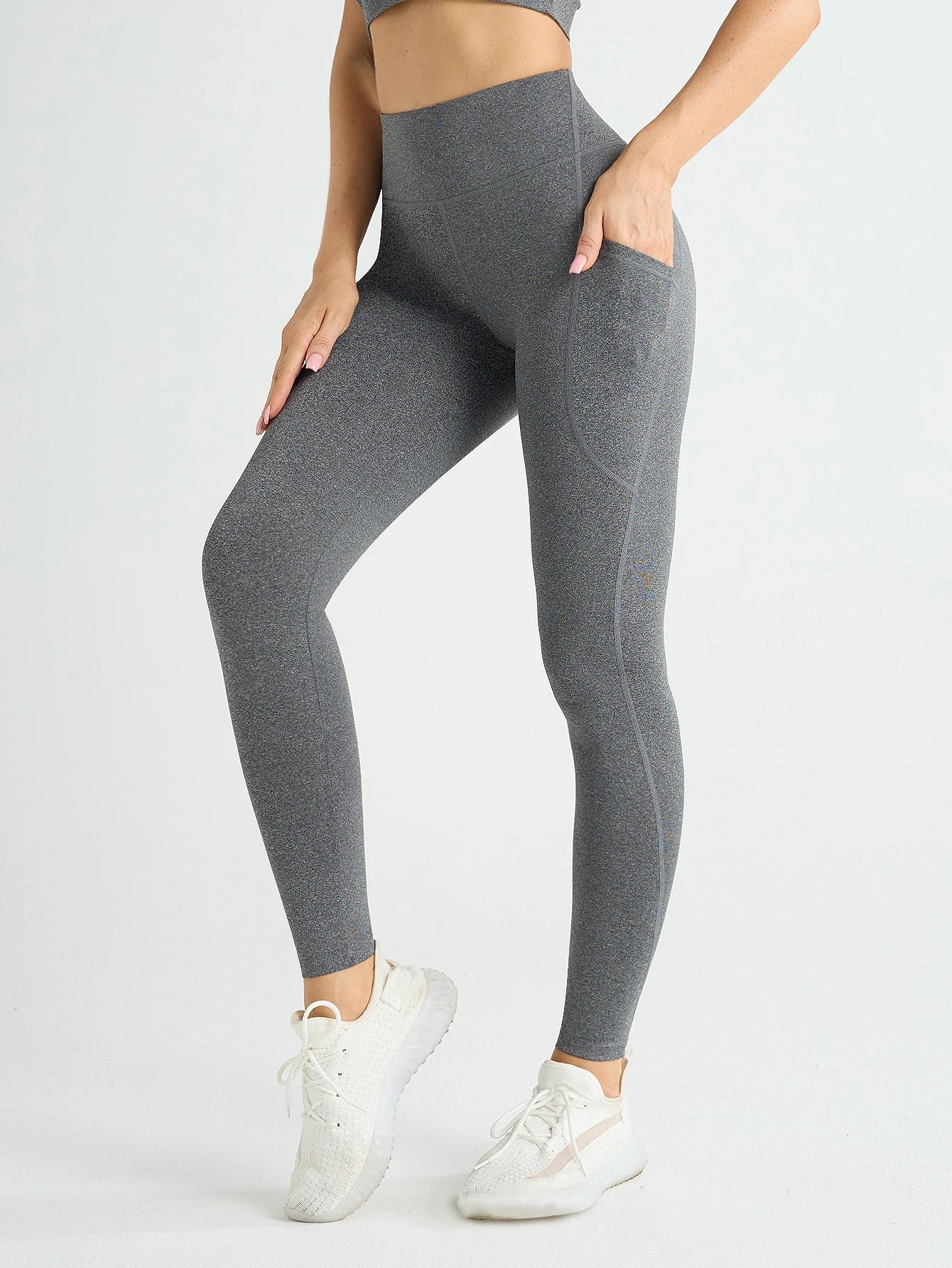 Person wearing gray leggings on a white background