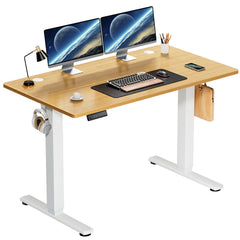 Wooden desk with white legs, two computer monitors, keyboard, and office supplies on a white background