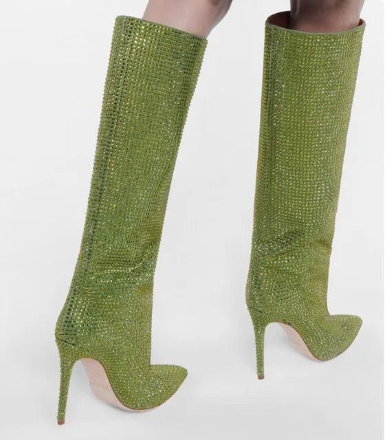 Green stiletto boots with rhinestone embellishments on a white background