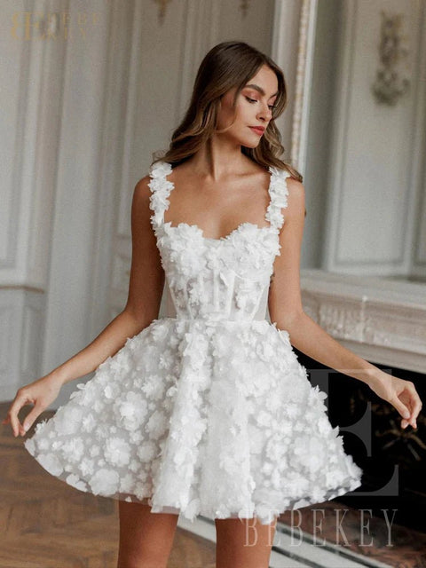 Woman wearing a white floral dress in an elegant indoor setting