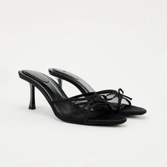 Black high-heeled sandals on a white background