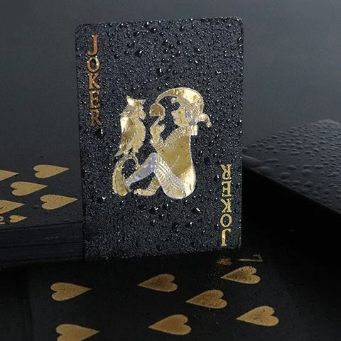 Black playing card with gold designs and 'JOKER' text on a dark background