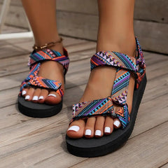 Colorful patterned sandals on a wooden floor