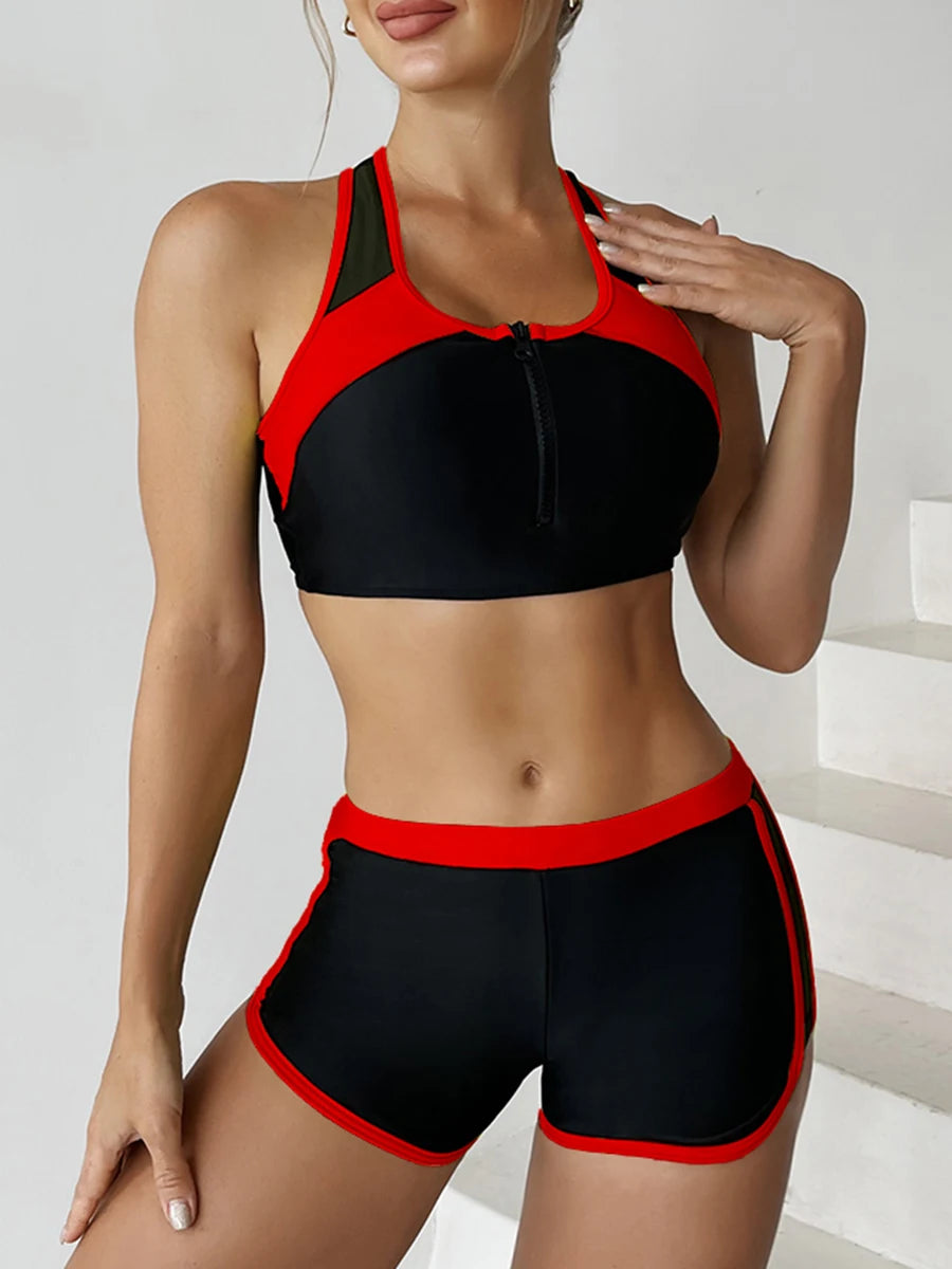 Black and red sports bra and shorts set on a plain background