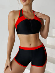 Black and red sports bra and shorts set on a plain background