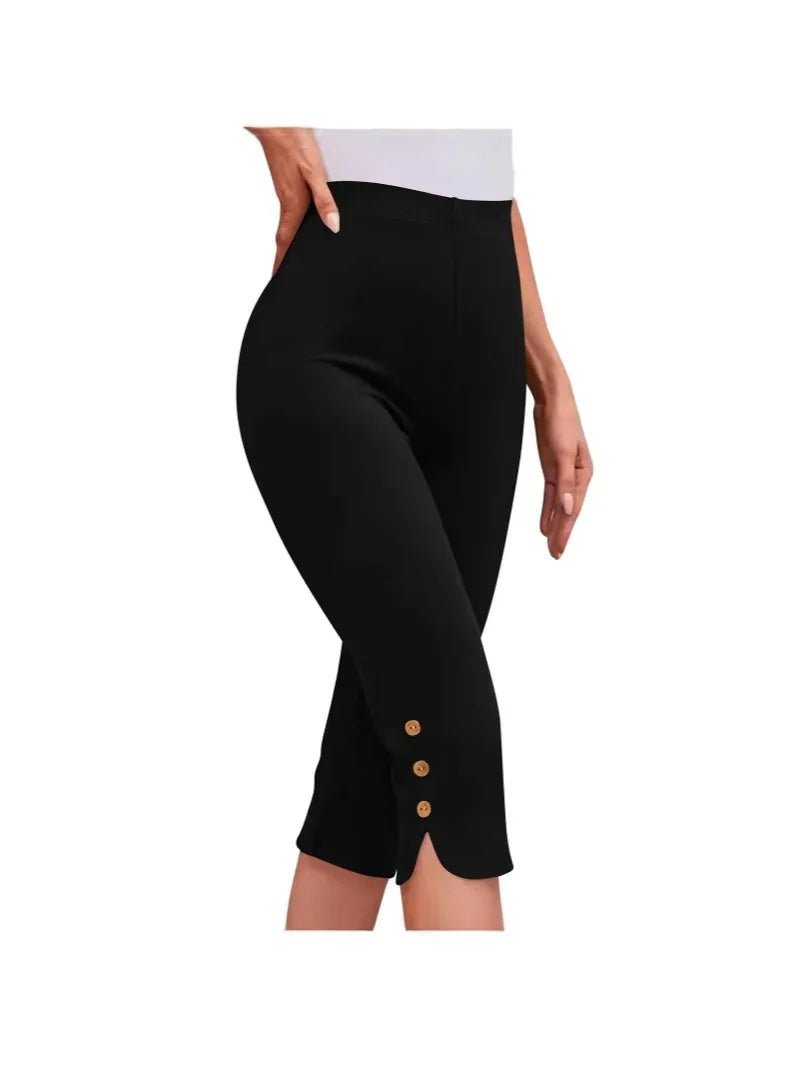 Black capri pants with button details on a white background