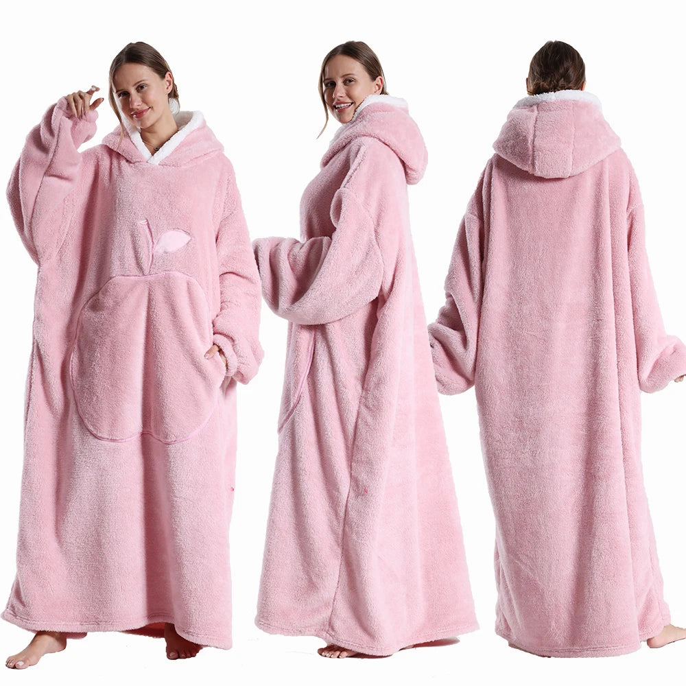Pink hooded blanket worn by a model on a white background