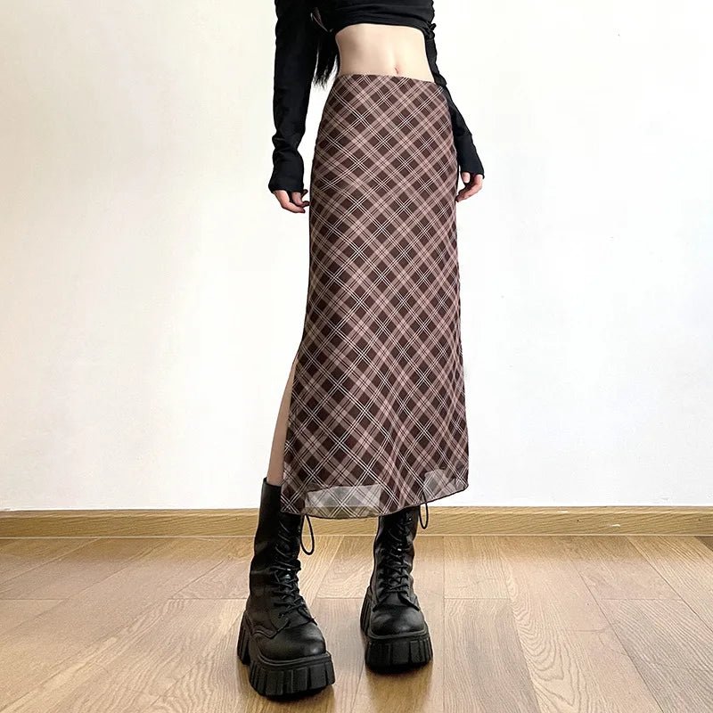 Person wearing a plaid skirt and black boots on a wooden floor.