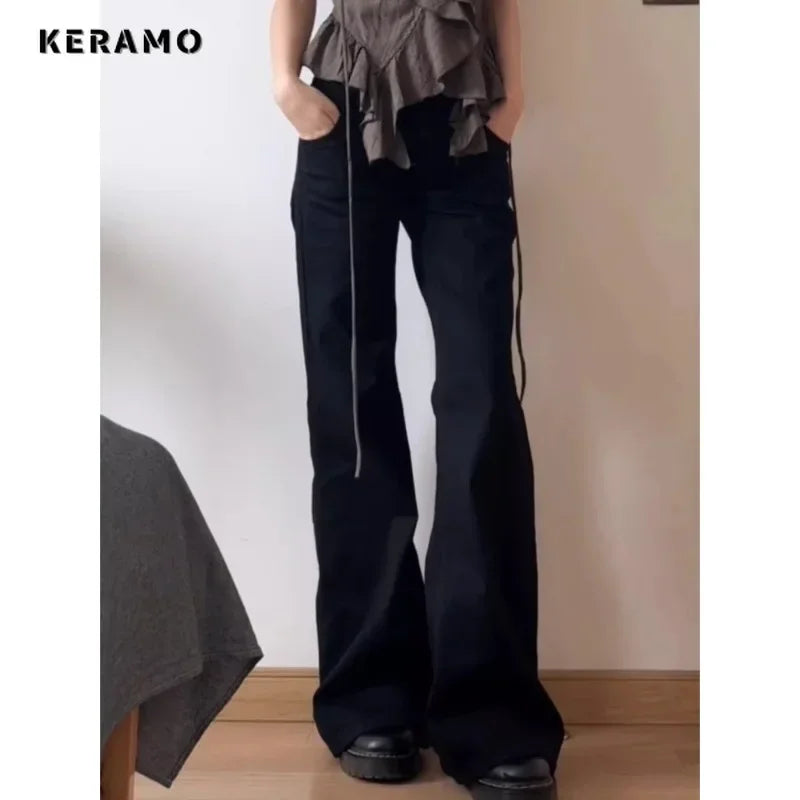 Person wearing black flared pants with a plain background and 'KERAMO' branding.