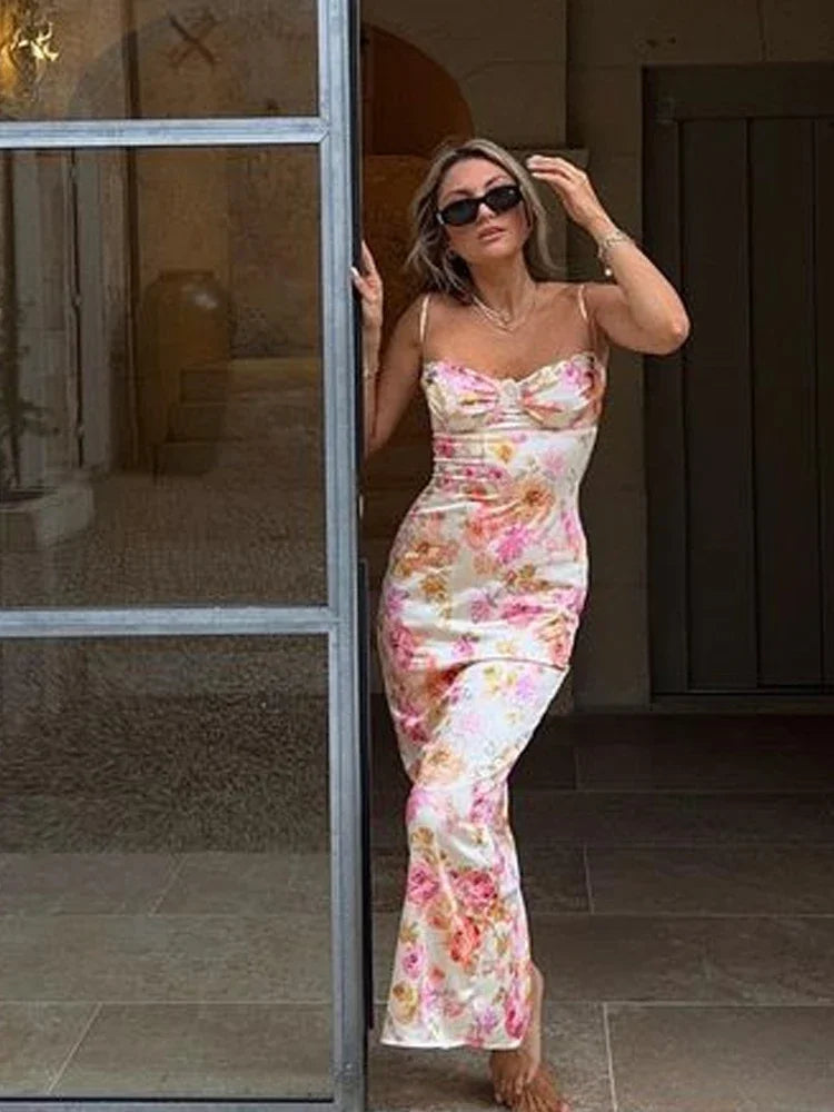 Woman in a floral dress standing in a doorway.