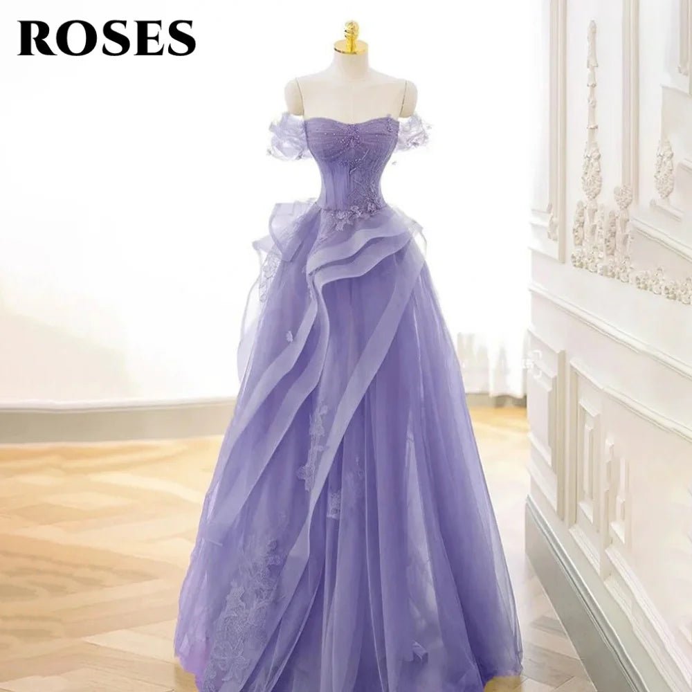 Purple evening gown on a mannequin against a white wall.