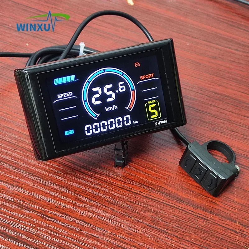 Digital speedometer with WINXU branding on a wooden surface