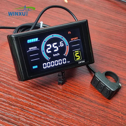 Digital speedometer with WINXU branding on a wooden surface