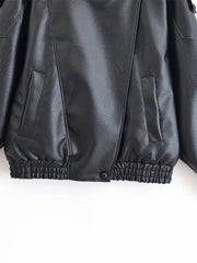 Close-up of a black leather jacket on a white background