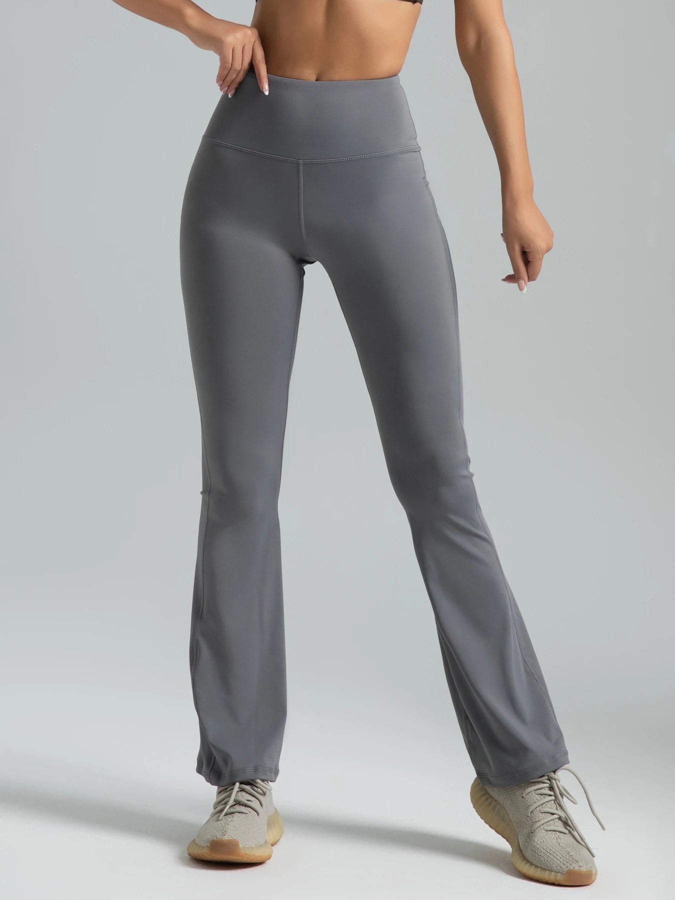 Gray leggings worn by a person on a plain background