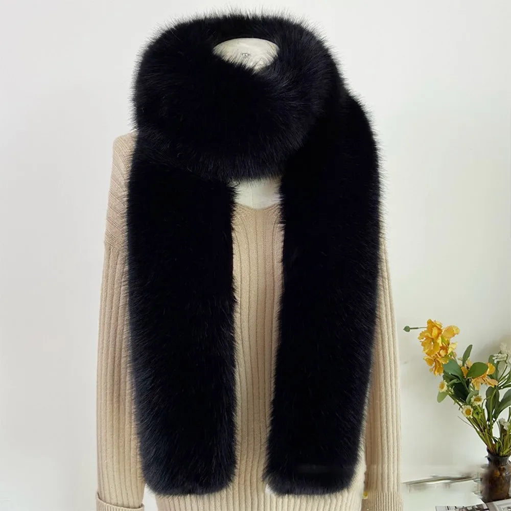 Black fur scarf draped over a beige sweater with a white background