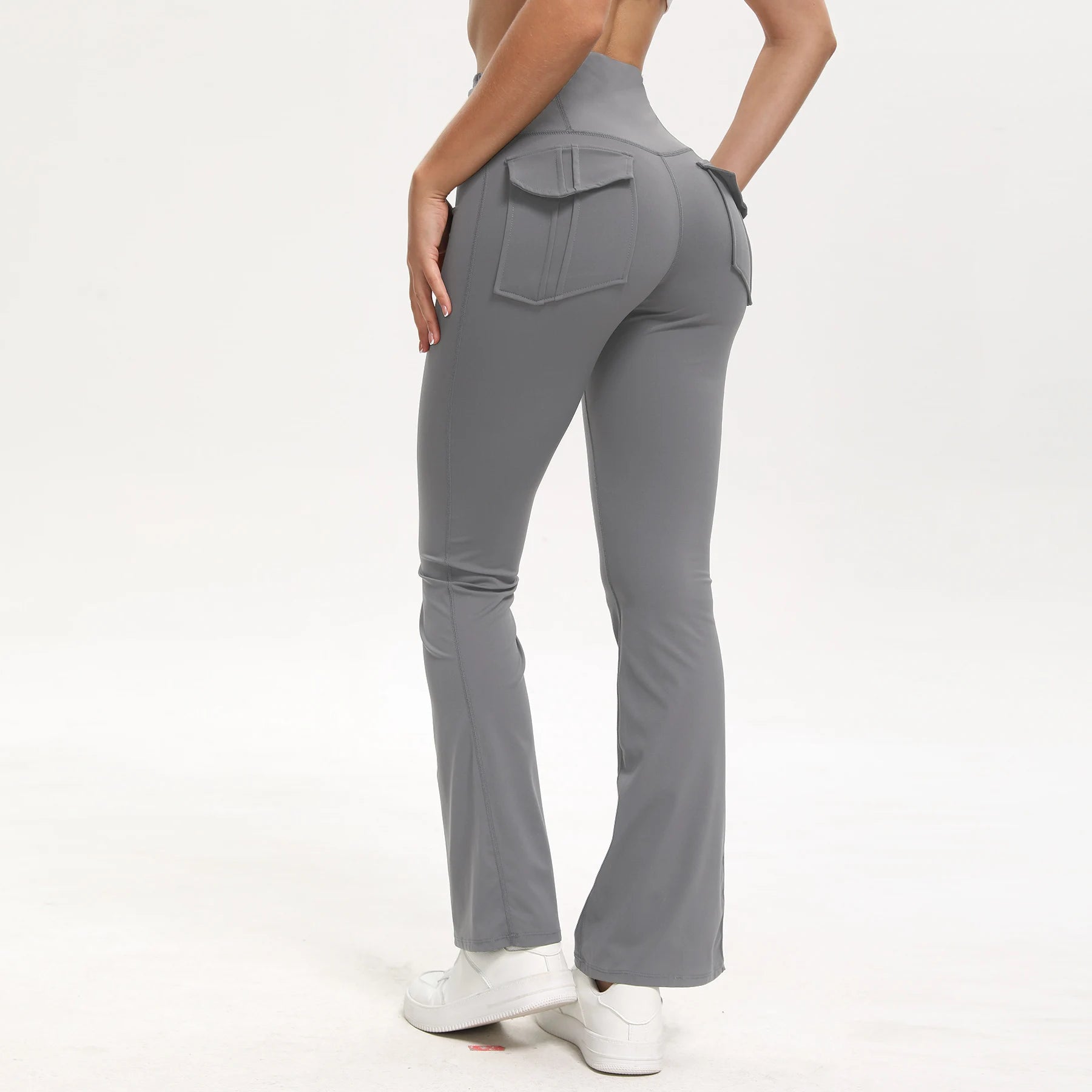 Gray flared pants worn by a person on a white background