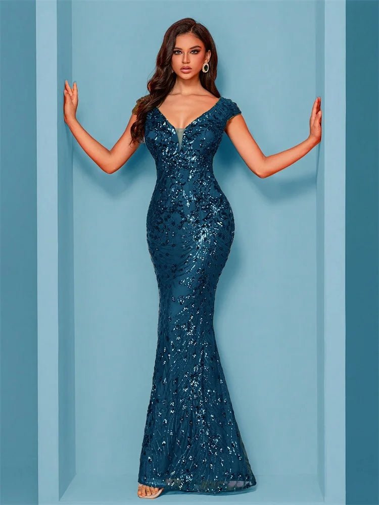 Woman wearing a blue sequin gown against a light blue background