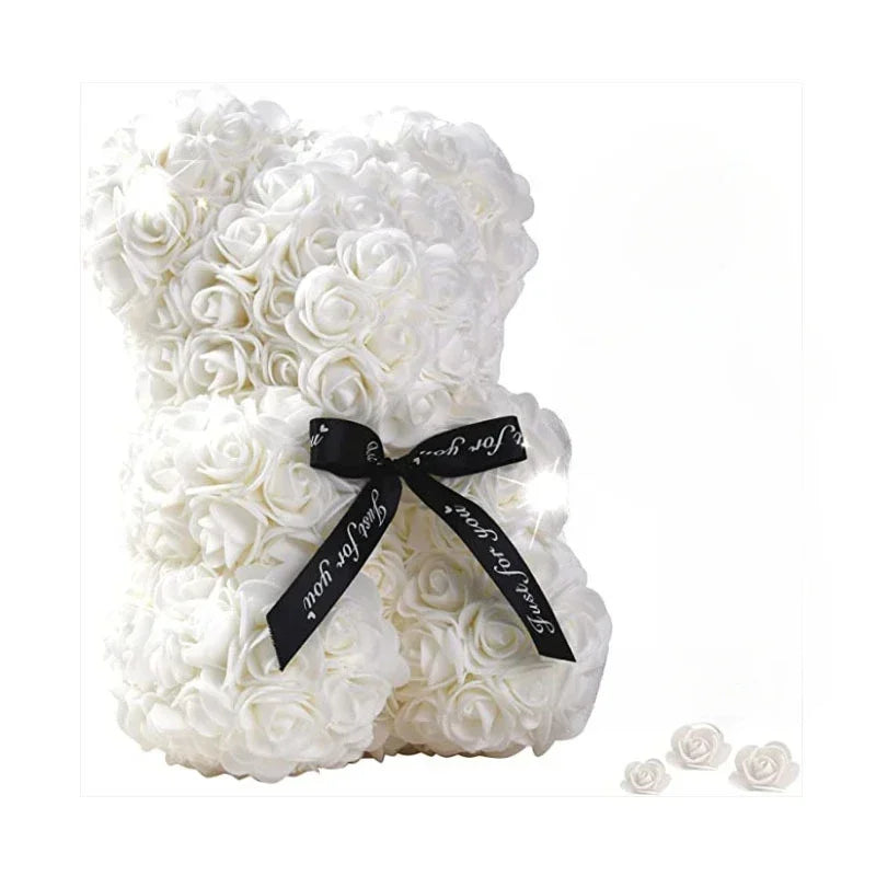 White rose teddy bear with a black ribbon on a white background