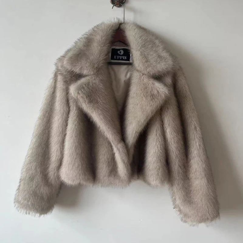 Beige fluffy jacket on a hanger against a white background