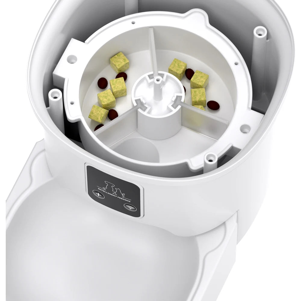 White pet food dispenser with compartments filled with dog treats on a white background
