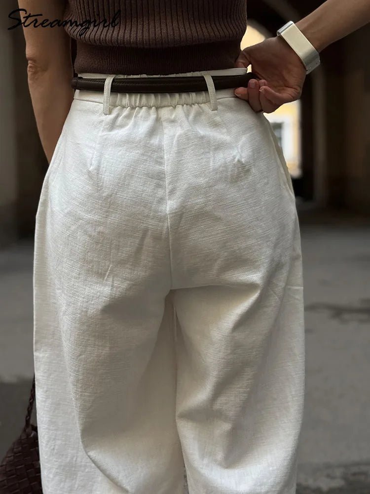 White wide-leg pants worn by a person with a blurred background