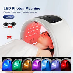 LED Photon Machine with a person receiving treatment, featuring 100 LEDs and gift items.