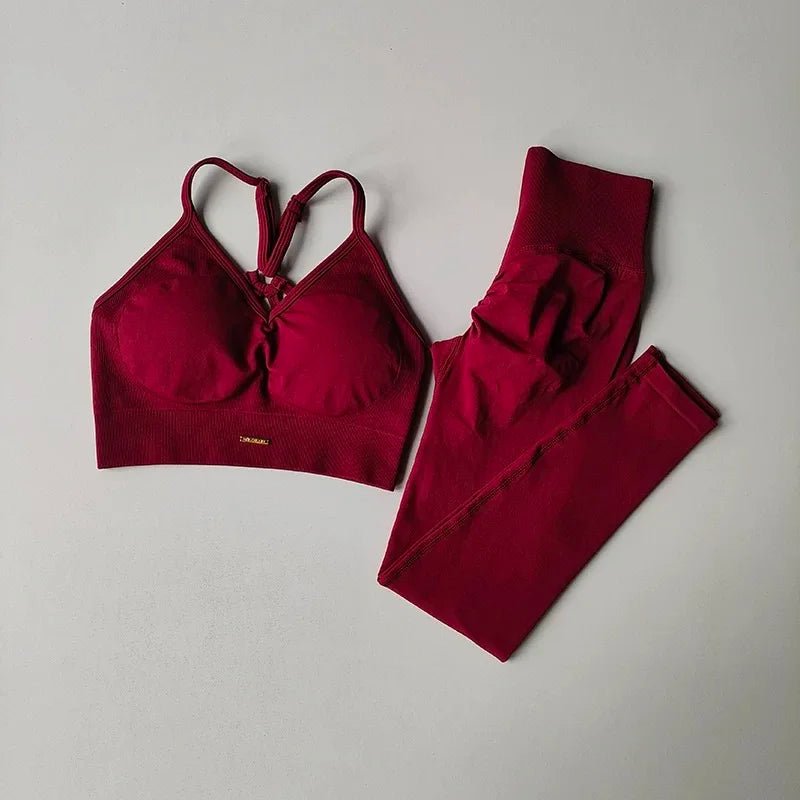 Red sports bra and leggings set on a light gray background