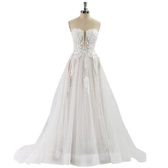 White lace wedding dress on a mannequin against a white background