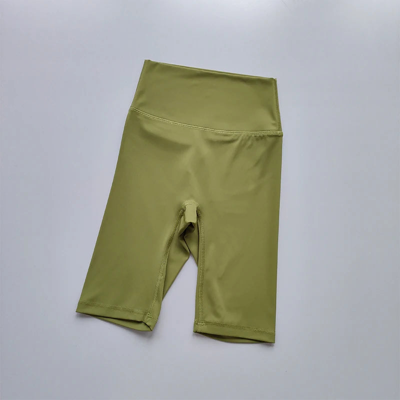 Green athletic shorts on a light gray background