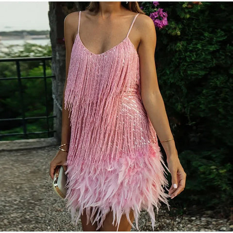 Person wearing a pink feathered dress with a blurred background