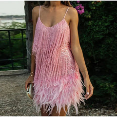 Person wearing a pink feathered dress with a blurred background