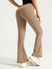 Beige flared pants worn by a person on a white background