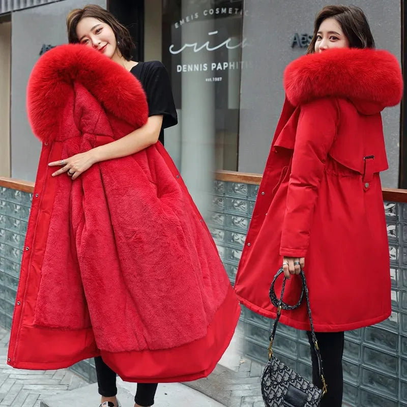 Close-up of faux fur hood and plush lining on women's long winter parka - red