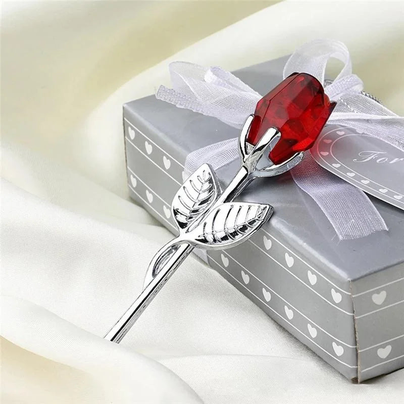 Silver rose with a red gemstone on a decorative box
