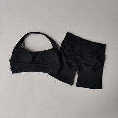 Black bikini set with a bow on a light gray background