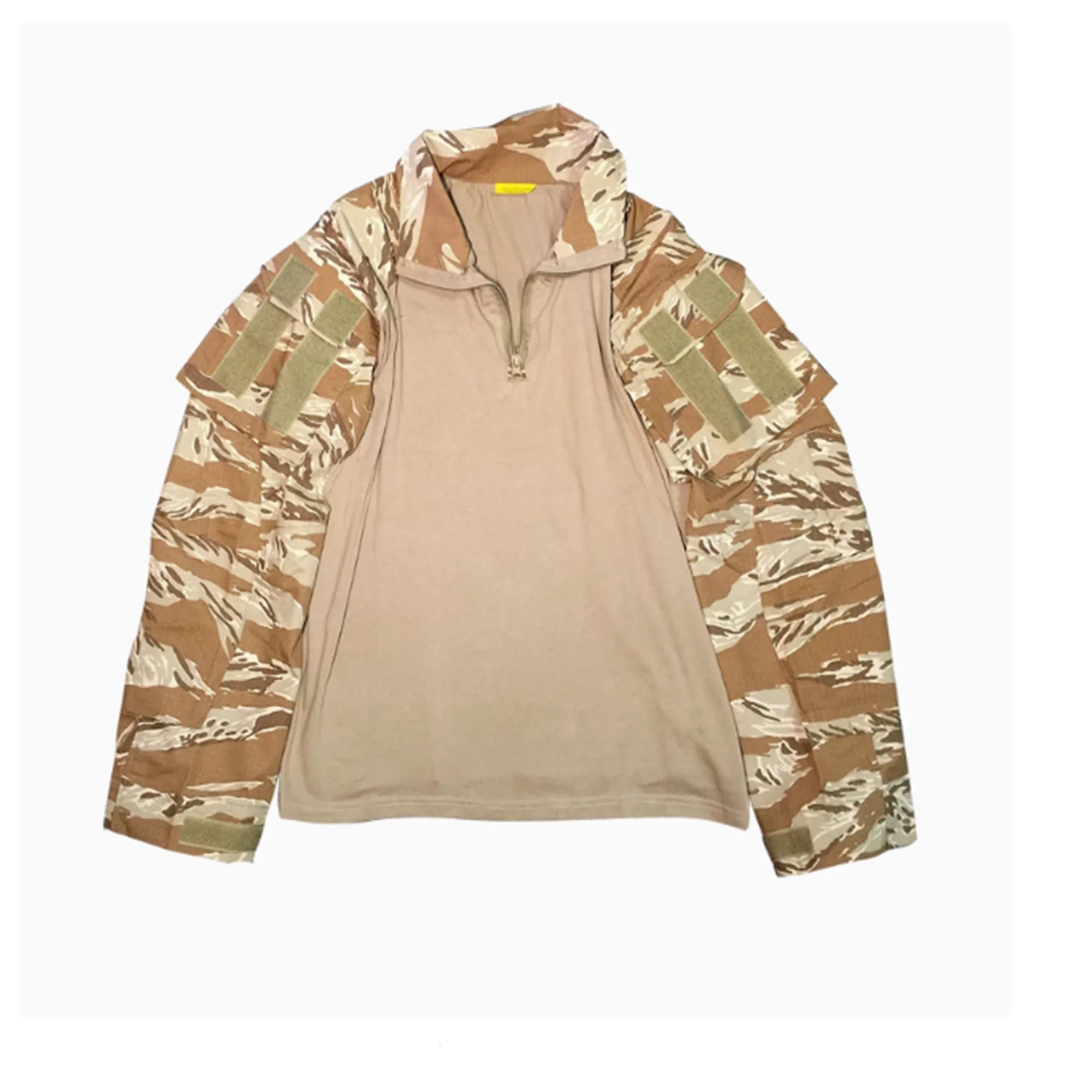 Camouflage jacket over a beige shirt on a white background