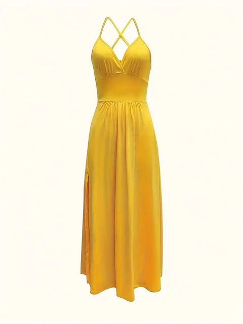 Yellow dress with criss-cross straps on a white background