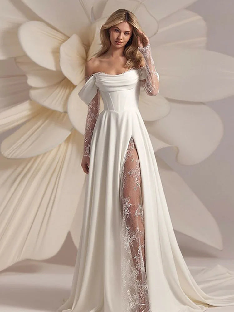 Woman wearing a white wedding dress with floral lace details against a floral background