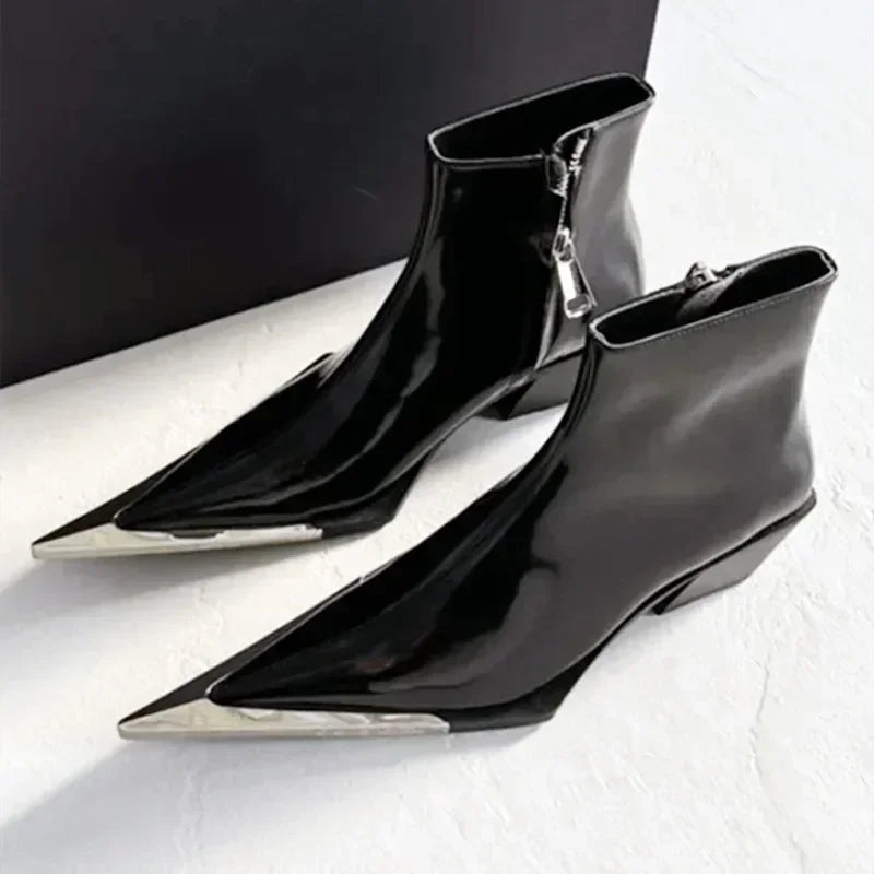 Black pointed-toe ankle boots with silver zippers on a white background