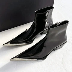 Black pointed-toe ankle boots with silver zippers on a white background